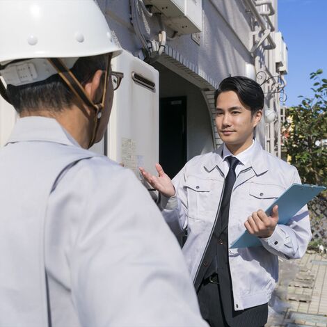 建物の前で打ち合わせするスタッフたちjpeg
